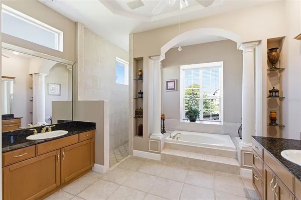 a view of a patio with a dining table and chairs with wooden floor