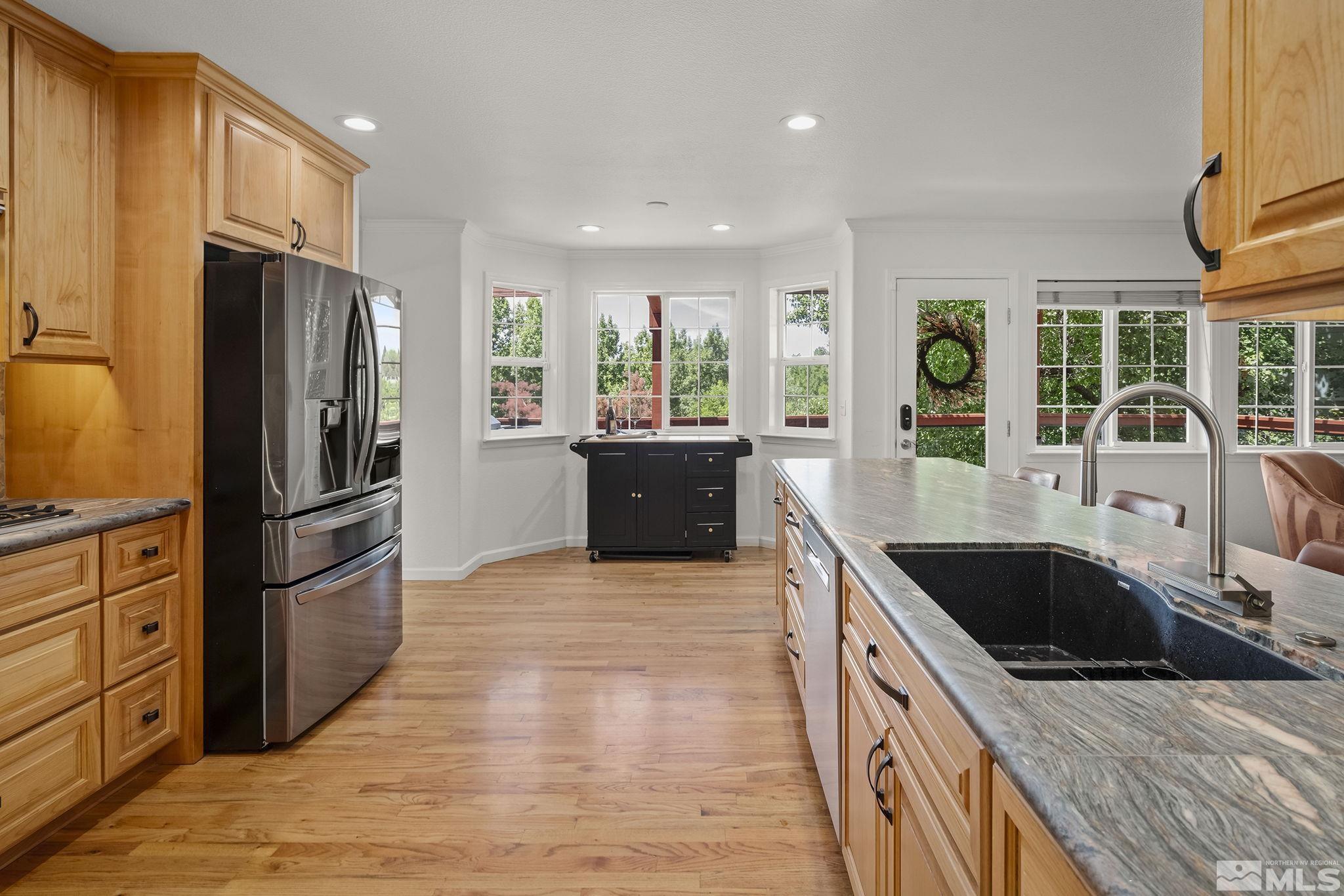 3341 Corey Drive Reno, NV 89509 - Photo 11 of 40 a kitchen with granite countertop a refrigerator and a sink