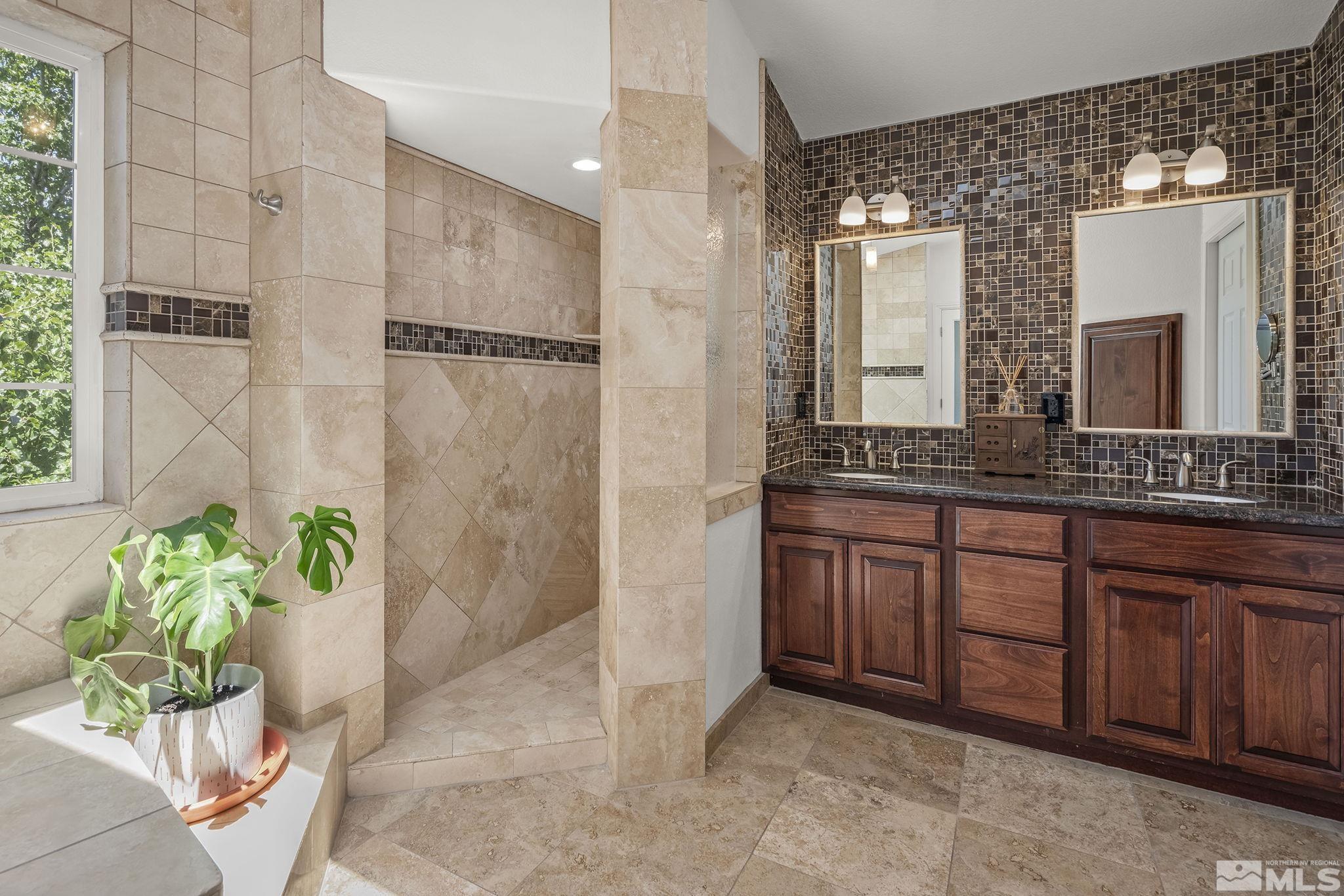 3341 Corey Drive Reno, NV 89509 - Photo 20 of 40 a bathroom with a granite countertop sink a mirror and a shower