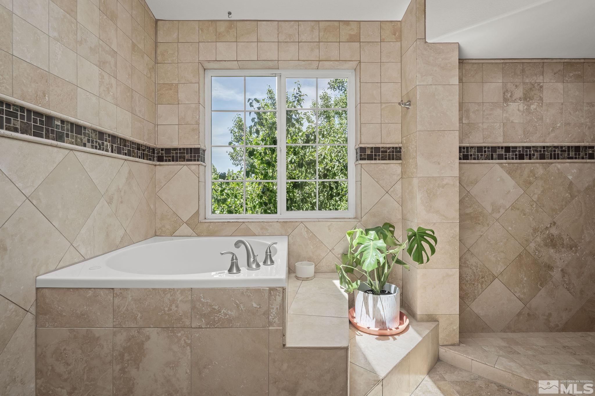 3341 Corey Drive Reno, NV 89509 - Photo 21 of 40 a bath tub sitting in a bathroom next to a window