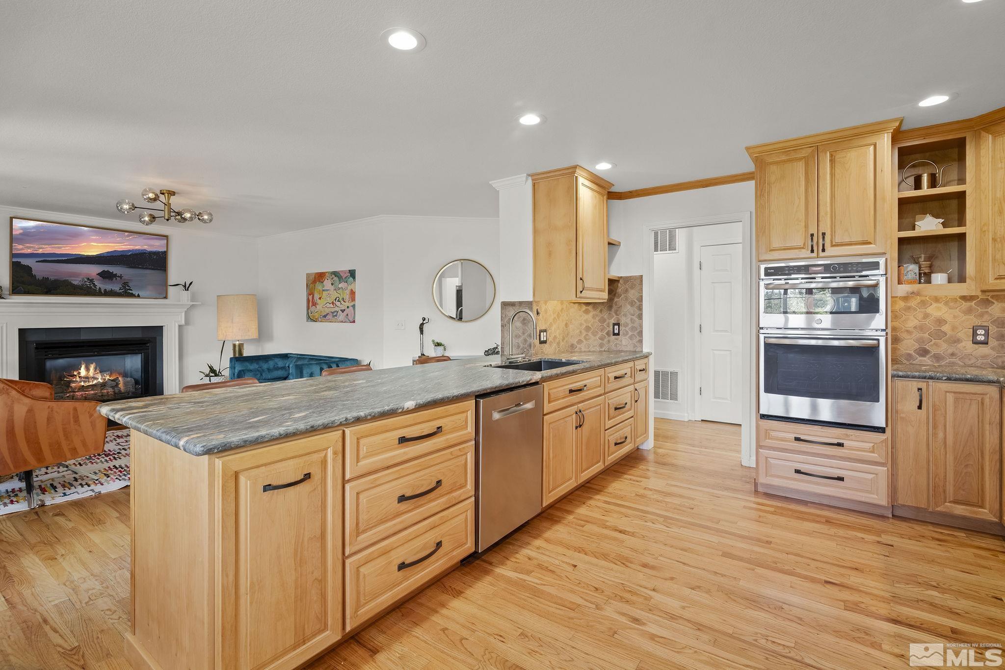 3341 Corey Drive Reno, NV 89509 - Photo 10 of 40 a spacious kitchen with stainless steel appliances granite countertop a stove a sink and a refrigerator