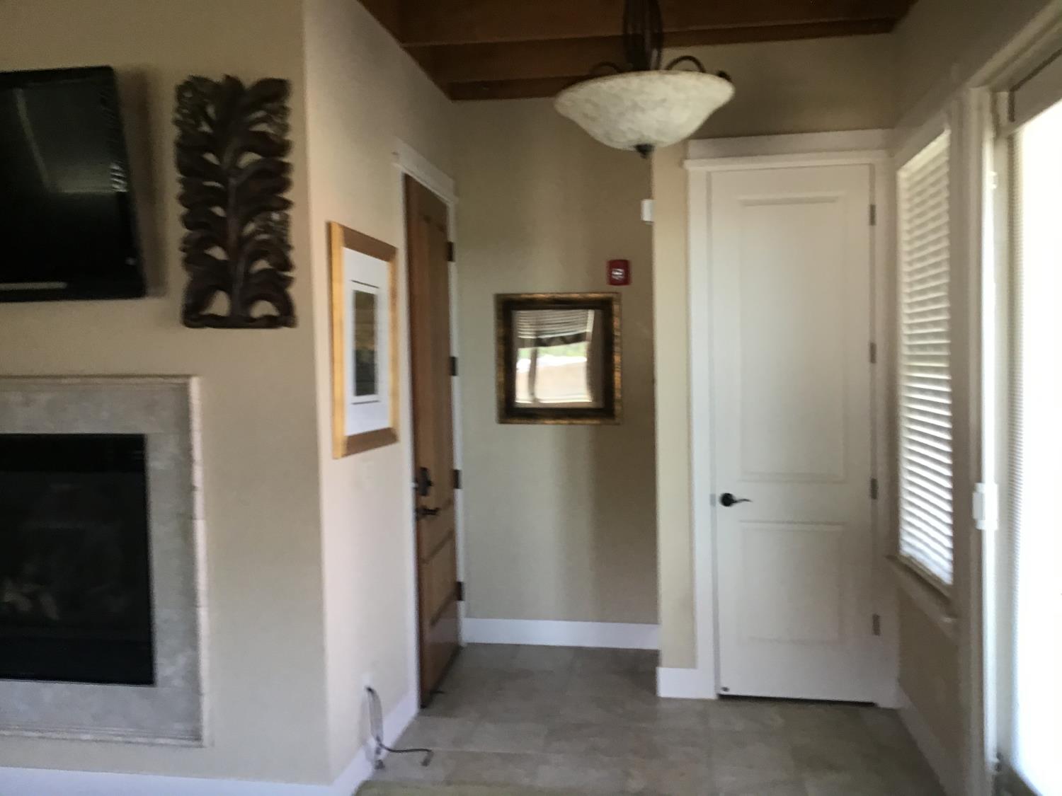 360 Town Square Road Copperopolis, CA 95228 - Photo 4 of 22 a view of a hallway with front door and wooden floor