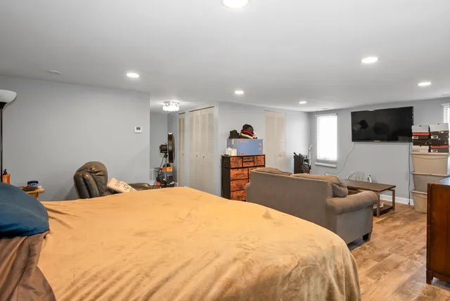 a large bedroom with a bed and a flat screen tv