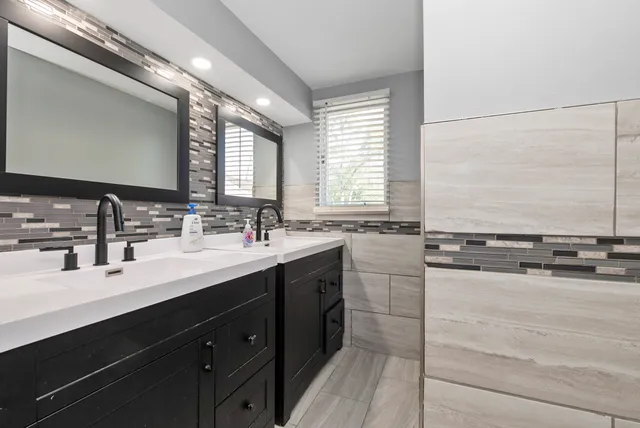 a bathroom with a sink double vanity and a mirror