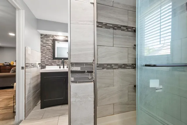 a bathroom with a shower and a sink