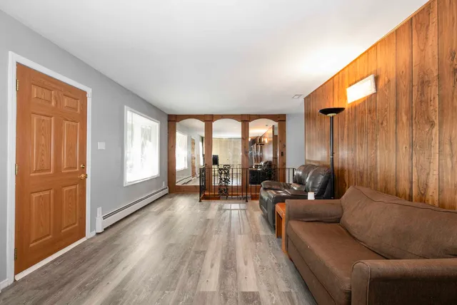 a living room with furniture and large windows