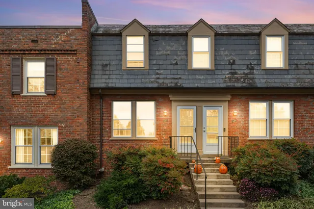 front view of a brick house with a large windows