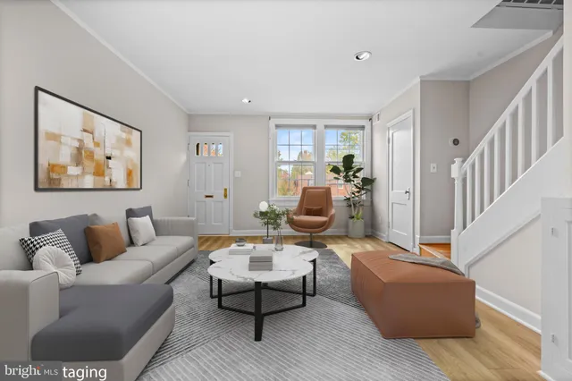 a living room with furniture and wooden floor