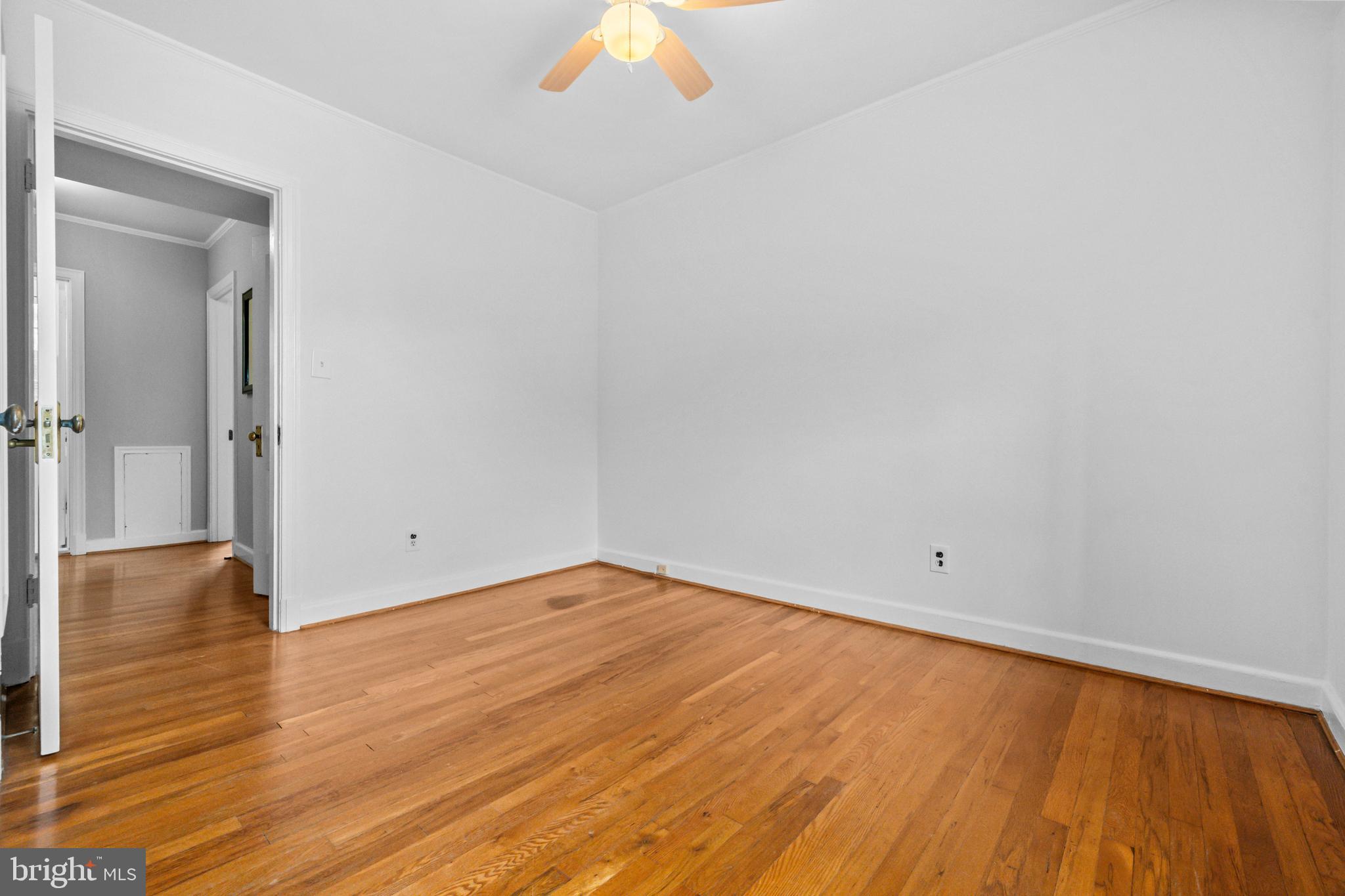 1400 South Edgewood Street, Unit 527 Arlington, VA 22204 - Photo 23 of 32 a view of an empty room with wooden floor and a window