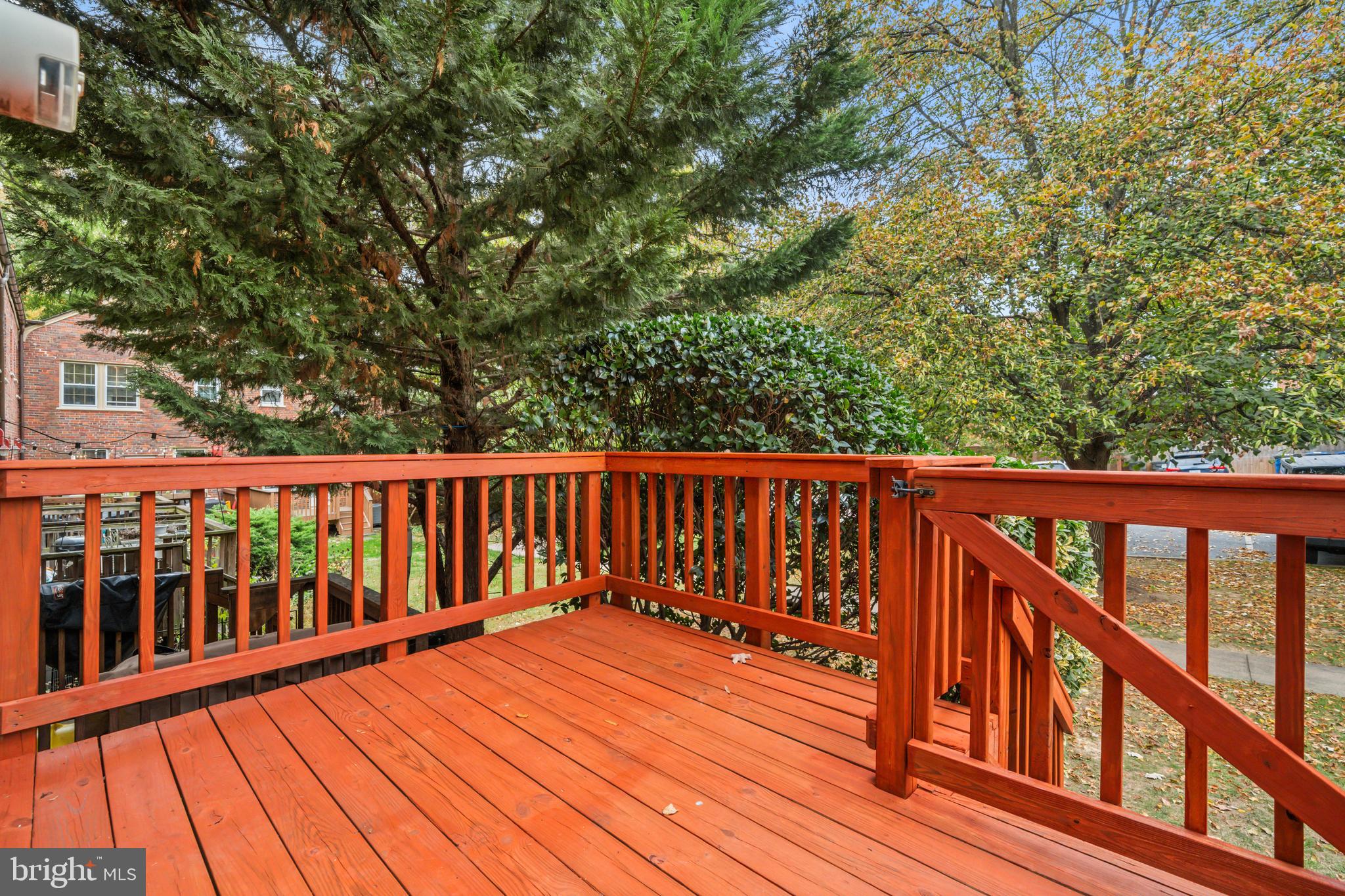 1400 South Edgewood Street, Unit 527 Arlington, VA 22204 - Photo 28 of 32 a balcony with wooden floor and trees