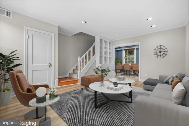 a living room with patio a couch and a potted plant