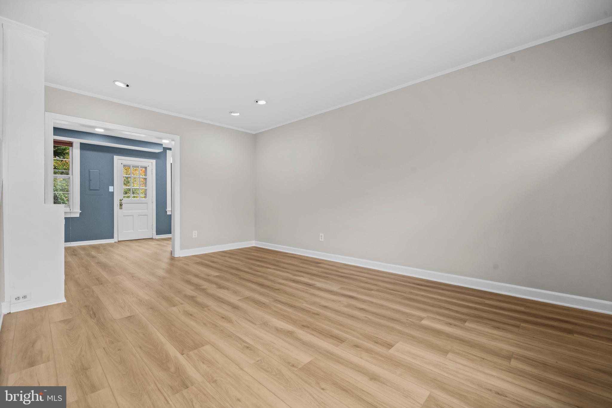 1400 South Edgewood Street, Unit 527 Arlington, VA 22204 - Photo 7 of 32 a view of an empty room with wooden floor and a window