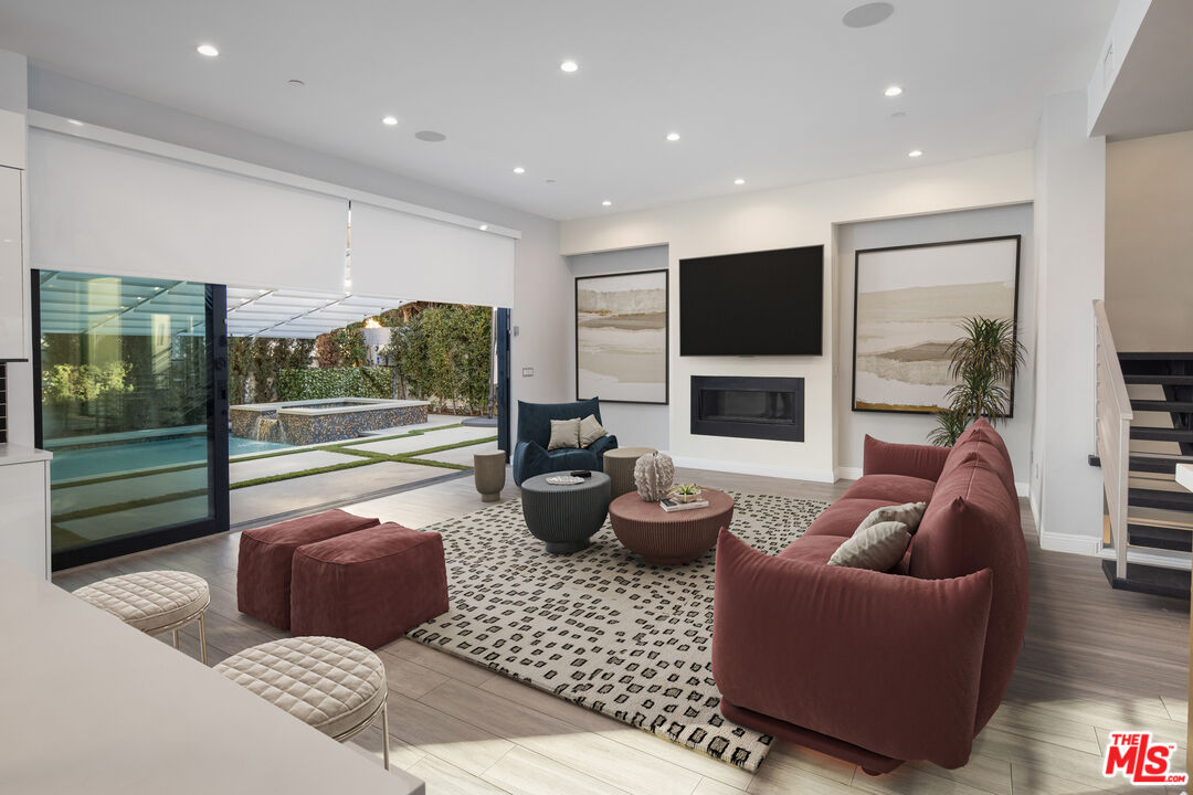 156 North Wetherly Drive Beverly Hills, CA 90211 - Photo 18 of 57 a living room with furniture floor to ceiling window and flat screen tv
