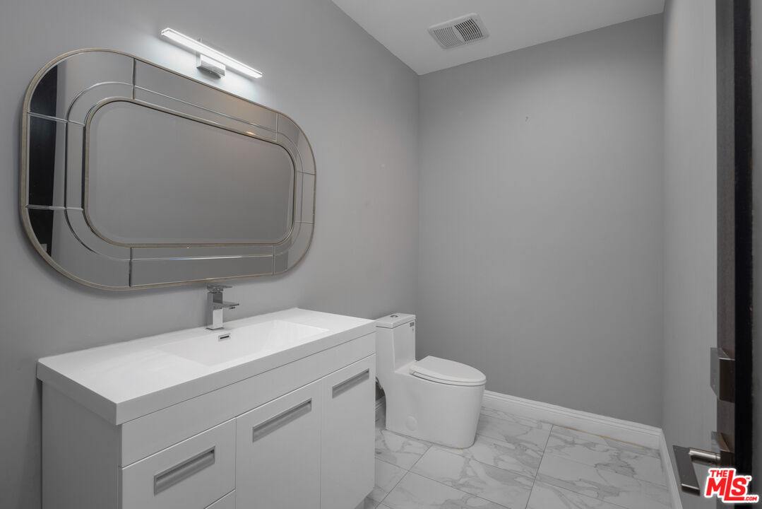 156 North Wetherly Drive Beverly Hills, CA 90211 - Photo 29 of 57 a bathroom with a sink mirror and toilet