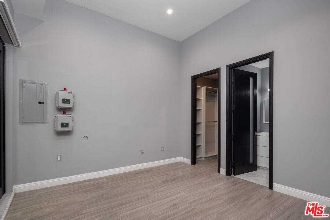 156 North Wetherly Drive Beverly Hills, CA 90211 - Photo 30 of 57 an empty room with wooden floor and closet