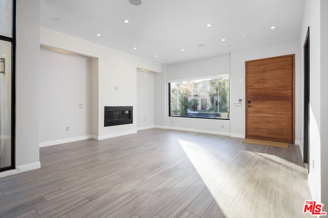 156 North Wetherly Drive Beverly Hills, CA 90211 - Photo 3 of 57 a view of an empty room with wooden floor and windows