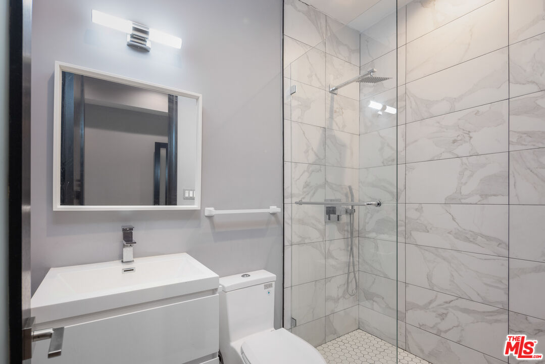 156 North Wetherly Drive Beverly Hills, CA 90211 - Photo 31 of 57 a bathroom with a toilet sink and shower