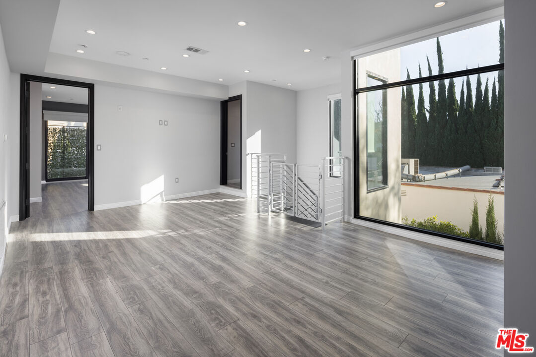 156 North Wetherly Drive Beverly Hills, CA 90211 - Photo 33 of 57 a view of a hallway with wooden floor and a living room