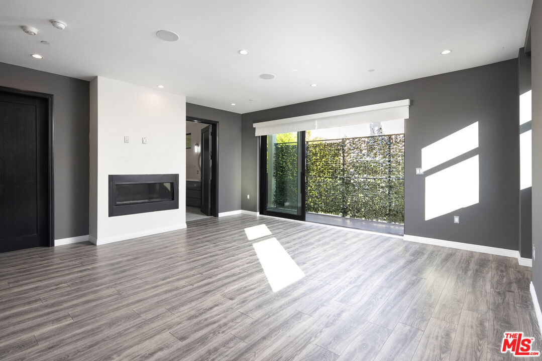 156 North Wetherly Drive Beverly Hills, CA 90211 - Photo 34 of 57 a view of an empty room with wooden floor and a window