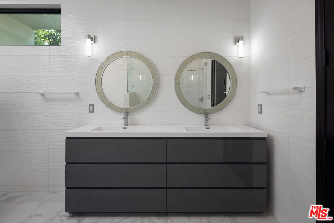 156 North Wetherly Drive Beverly Hills, CA 90211 - Photo 43 of 57 a bathroom with a sink and a mirror