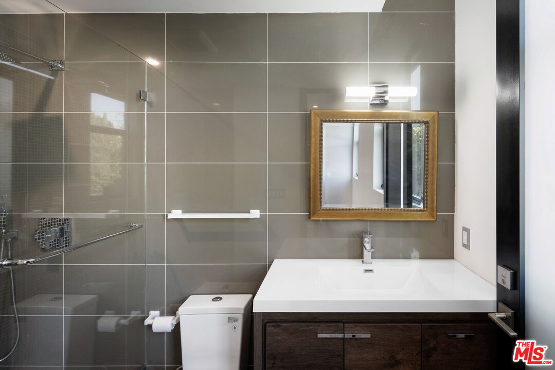 156 North Wetherly Drive Beverly Hills, CA 90211 - Photo 48 of 57 a bathroom with a sink a toilet and mirror
