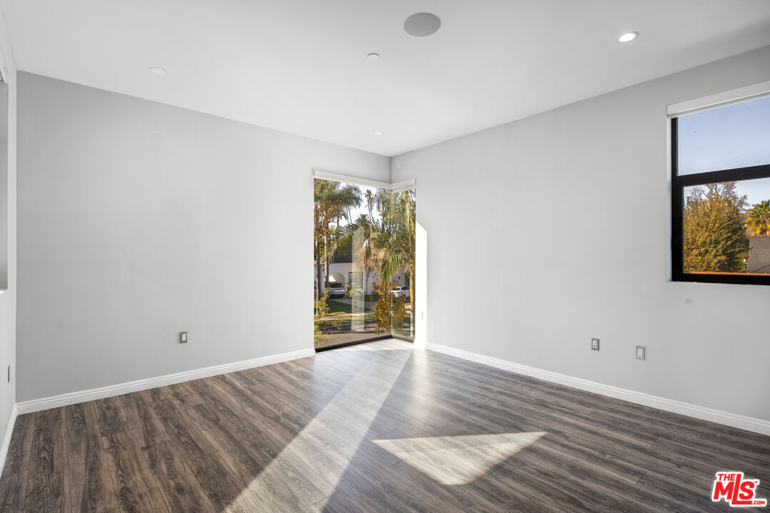156 North Wetherly Drive Beverly Hills, CA 90211 - Photo 49 of 57 a view of an empty room with wooden floor and a window