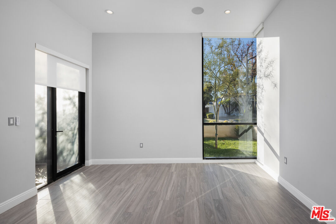 156 North Wetherly Drive Beverly Hills, CA 90211 - Photo 7 of 57 wooden floor in an empty room with a window