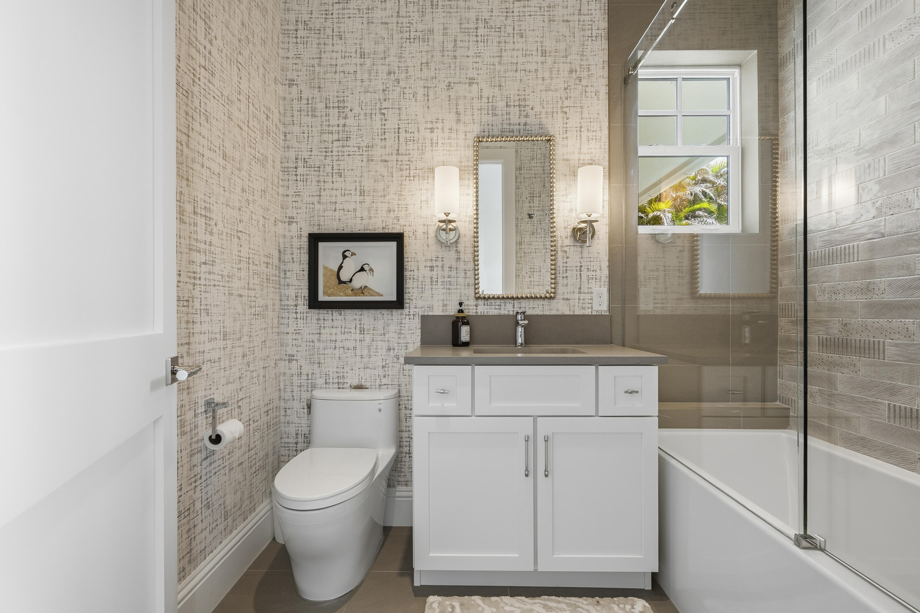 3973 Southeast Topsail Court Stuart, FL 34997 - Photo 21 of 38 a bathroom with a granite countertop toilet sink and mirror