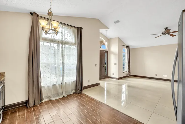 a view of an empty room with glass door