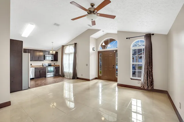 a view of a kitchen with a sink and a refrigerator
