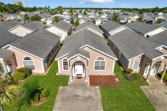 an aerial view of residential houses with yard