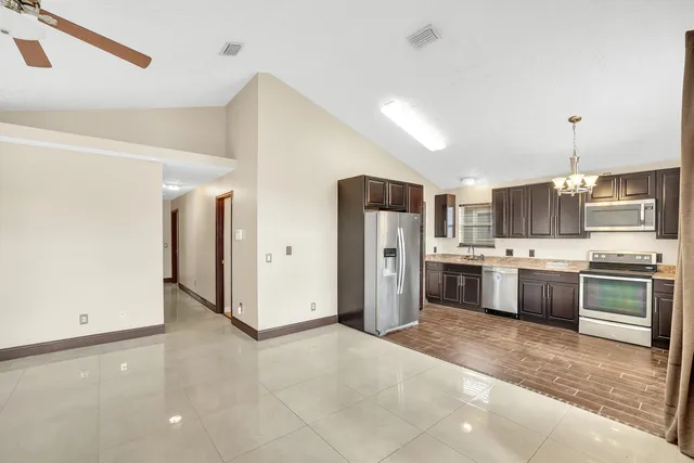 a kitchen with stainless steel appliances a refrigerator sink and stove