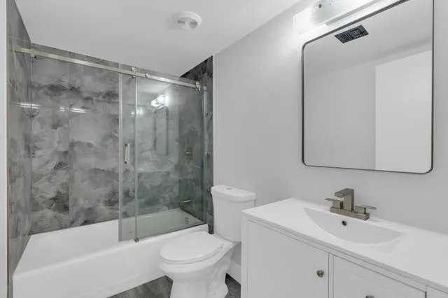 a bathroom with a sink mirror toilet and bathtub