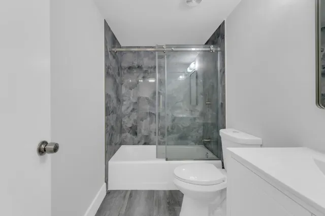 a bathroom with a toilet and a shower