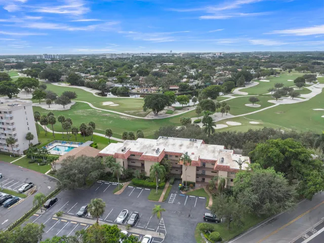 an aerial view of residential houses with outdoor space and ocean view