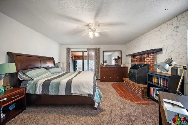 a bedroom with a bed dresser and a flat screen tv