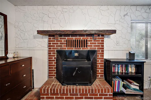 a room with fireplace and shelf