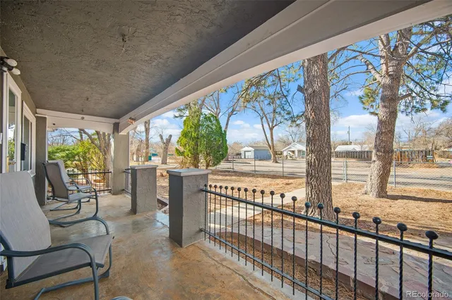 a view of a porch with furniture and garden