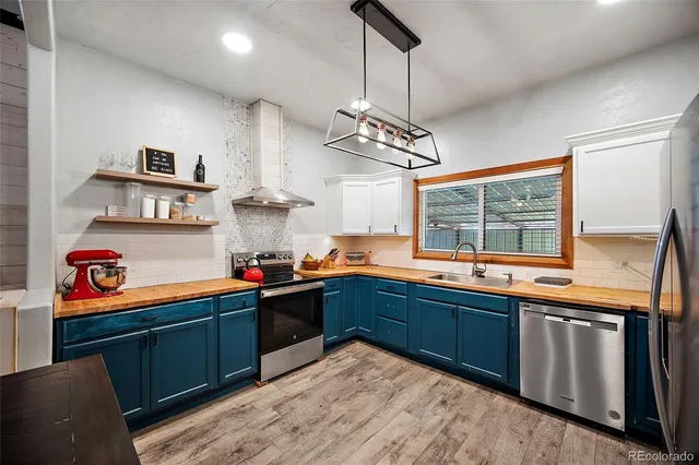 a kitchen with stainless steel appliances granite countertop sink stove and cabinets