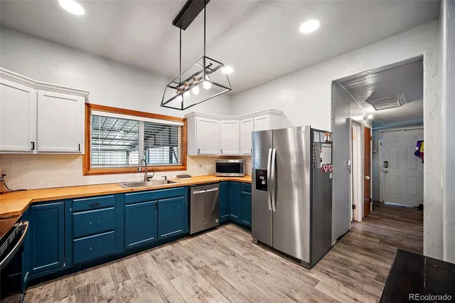a kitchen with stainless steel appliances granite countertop cabinets and wooden floor