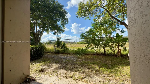 a view of a yard with large trees