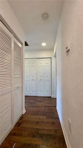 a view of hallway with wooden floor