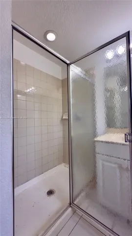 a bathroom with a shower and a sink