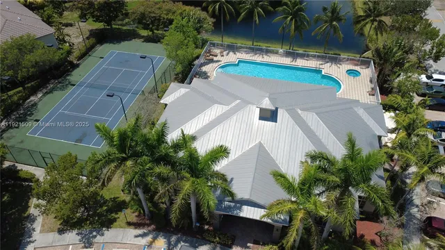 an aerial view of a house with garden space and a patio