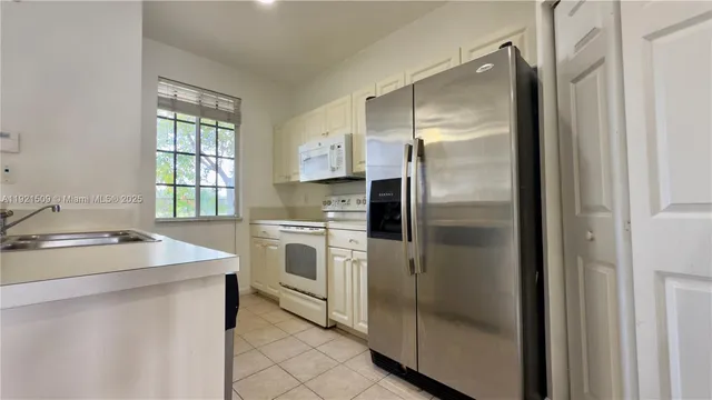 a kitchen with a refrigerator sink and stove