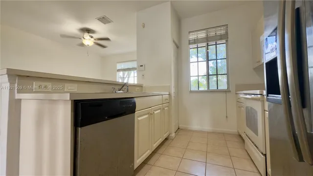 a kitchen with a refrigerator a sink and dishwasher