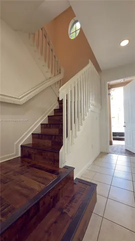 a view of entryway and hall with wooden floor