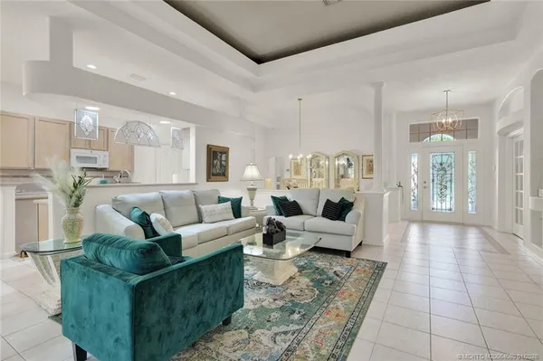 a living room with furniture and a floor to ceiling window