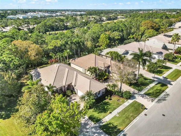 an aerial view of a house with a yard and lake