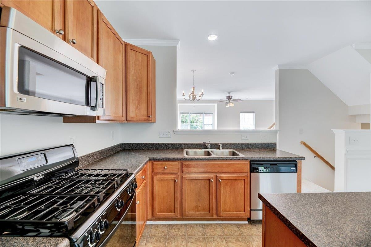 11838 Canemount Street Raleigh, NC 27614 - Photo 11 of 34 a kitchen with stainless steel appliances granite countertop a stove and a microwave